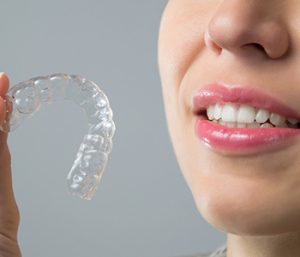 Dr oliviya heart, Virginia Biological Dentistry Smiling Woman with silicone trainer. Invisible braces