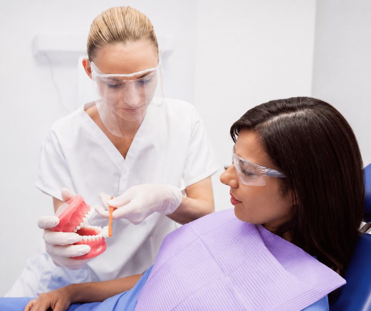 Dentist explaining findings on a dental model